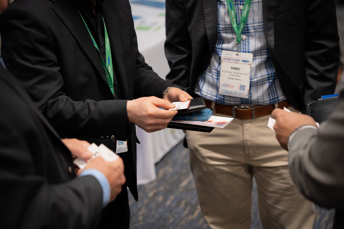 Delegates exchanging business cards at eh american hydrogen forum